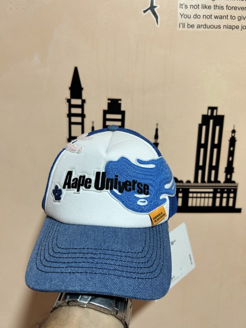 Aape Universe Trucker Cap Blue White Denim Mesh (Category: Caps & Hats) located in General Santos City (Dadiangas). Submitted by moana_thrifts (Listing ID 1462768052, Image 1). Description: - Aape Universe trucker cap - Denim brim and front panel - White and blue graphic details on the front - Breathable mesh back - Adjustable snapback closure - Comes with original tags attached - Ideal for casual wear.
