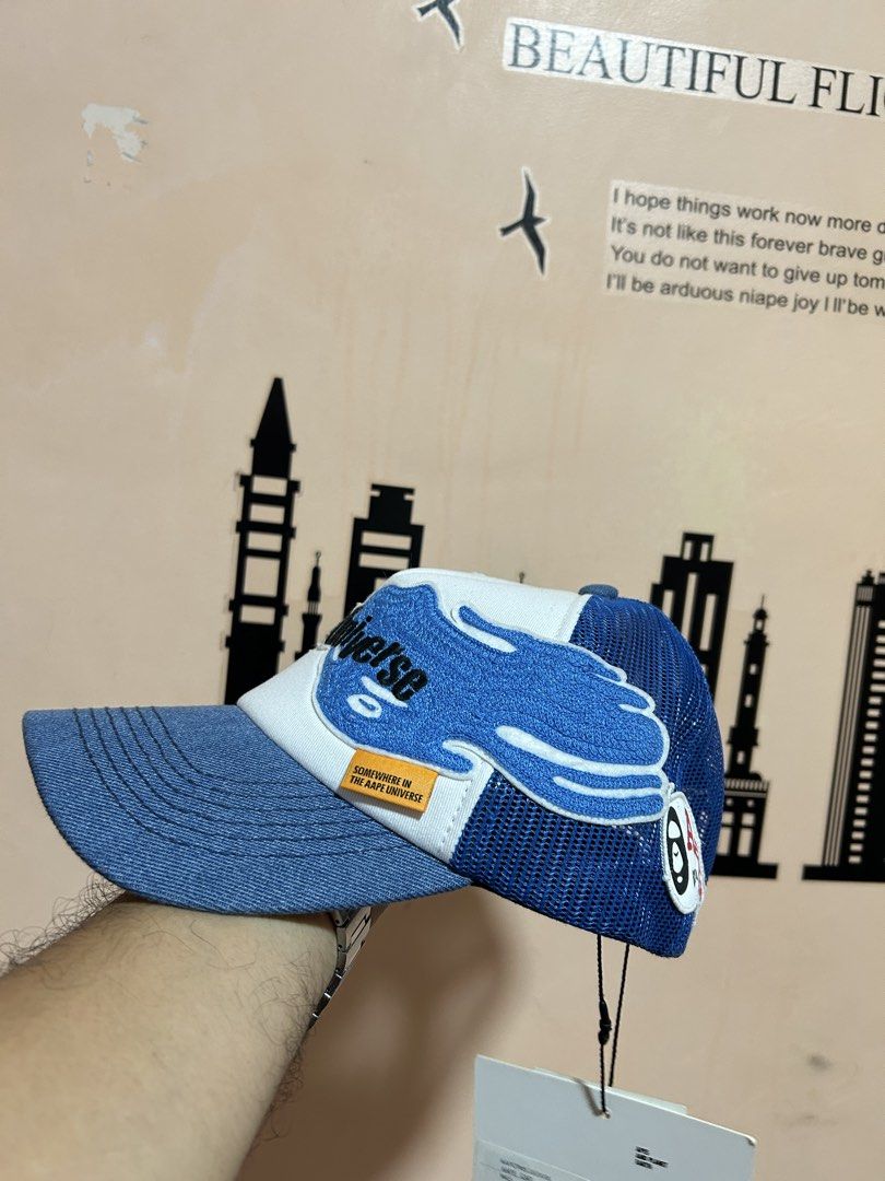 Aape Universe Trucker Cap Blue White Denim Mesh (Category: Caps & Hats) located in General Santos City (Dadiangas). Submitted by moana_thrifts (Listing ID 1462768052, Image 2). Description: - Aape Universe trucker cap - Denim brim and front panel - White and blue graphic details on the front - Breathable mesh back - Adjustable snapback closure - Comes with original tags attached - Ideal for casual wear.