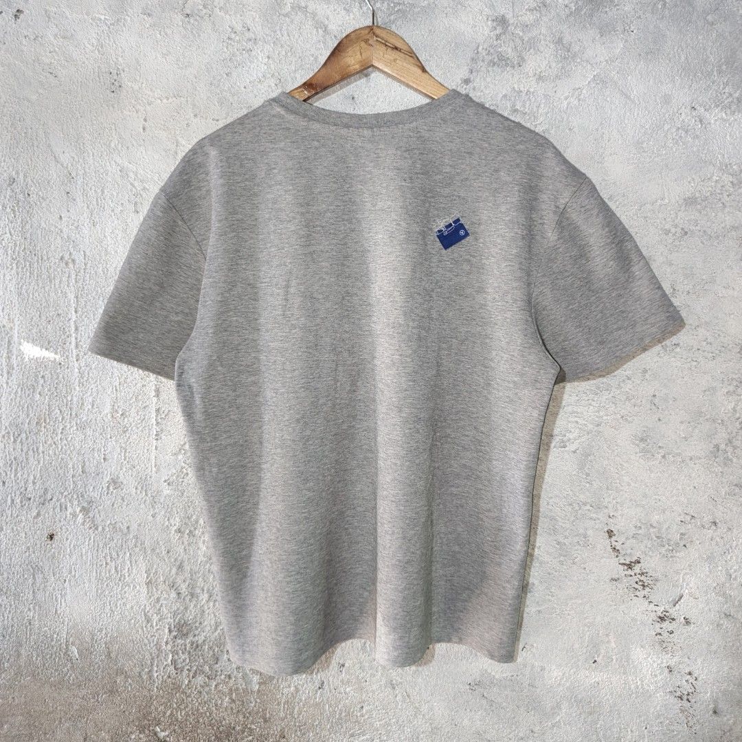 ADER Error | Men's Grey T-Shirt Pocket Tee (Category: Tshirts & Polo Shirts ) located in Naga. Submitted by bossyingthrifts (Listing ID 1462772588, Image 3). Description: ADER Error | Men's Grey T-Shirt Pocket Tee - ADER Error Grey T-Shirt - Features a chest pocket with distressed detailing - Small ADER logo embroidered on the sleeve - Distinctive small blue tag near the collar - Ideal for casual and everyday styling Size: A1 on tag (can fit Larg