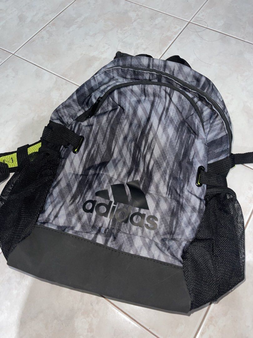 Adidas Backpack Grey Black Patterned (Category: Backpacks) located in Lucena. Submitted by jprl_0003 (Listing ID 1462739472, Image 1). Description: - Stylish grey and black patterned Adidas backpack. - Convenient side mesh pockets for water bottles or small items. - Vibrant lime green interior for easy visibility. - Spacious main compartment for all your essentials. - Smooth and reliable zippers. - Ideal for school, gym, or everyday adventures..