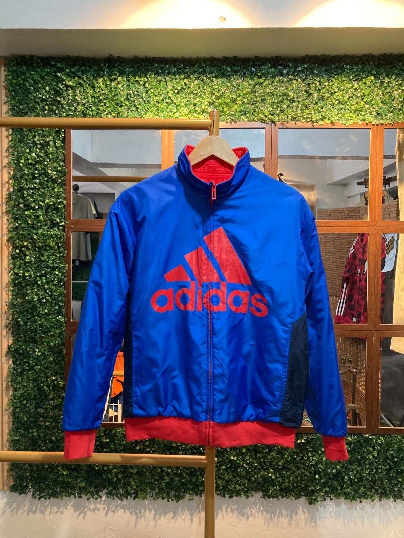 Adidas Reversible Track Jacket Blue Red (Category: Coats, Jackets and Outerwear) located in Trece Martires City. Submitted by djaothriftshop (Listing ID 1462783733, Image 1). Description: - Reversible Adidas jacket: two looks in one! - Side 1: Blue with a large red Adidas logo. - Side 2: Red with white stripes on the sleeves. - Ideal for casual wear or sports activities..
