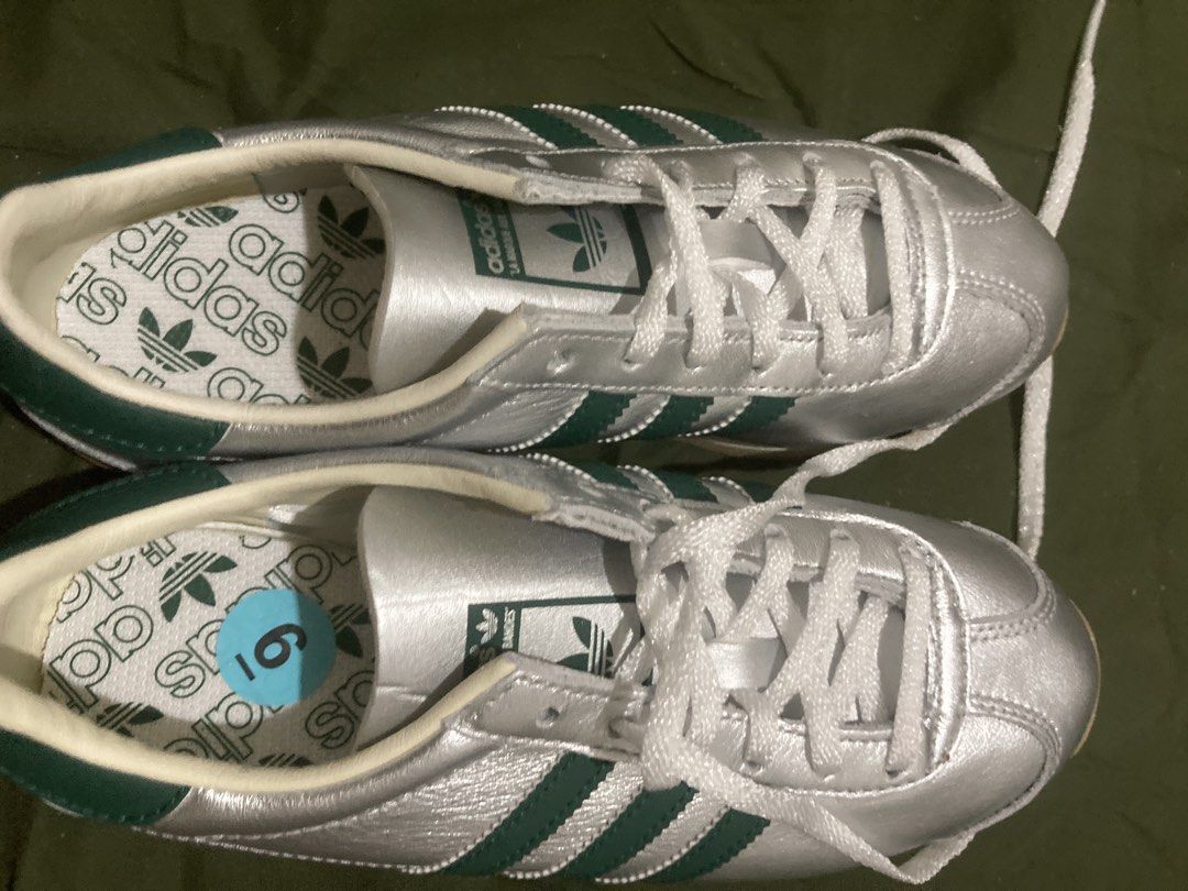 Adidas Silver Green Stripes Sneakers (Category: Sneakers) located in Tacloban City. Submitted by sid1999 (Listing ID 1462699801, Image 2). Description: - Silver Adidas sneakers - Features iconic green stripes - Classic lace-up closure - Made in Indonesia - Size: US 6 / UK 4.5 / FR 37.5 / JP 230 / CHN 230 (refer to label for full details) - Ideal for everyday casual wear.