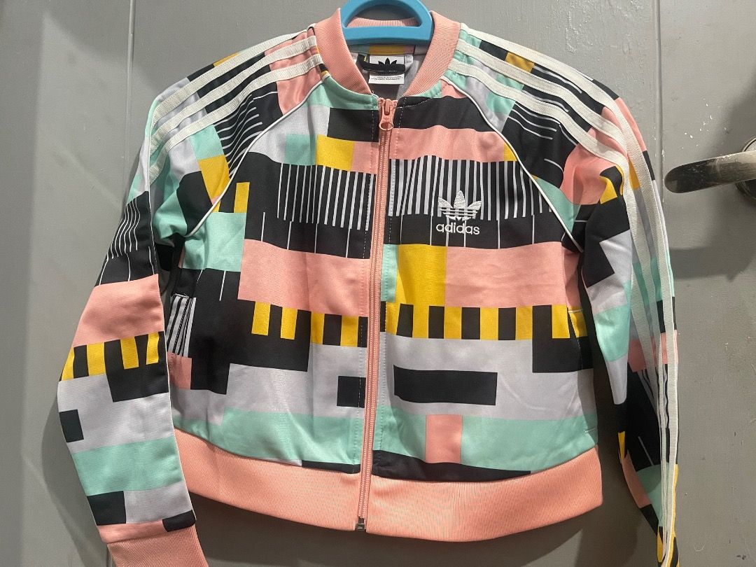 Adidas Track Jacket Multicolor Geometric Print (Category: Babies & Kids Fashion) located in Marikina City. Submitted by shemrisleb (Listing ID 1462731587, Image 1). Description: - Unique geometric print Adidas track jacket - Classic three stripes on sleeves - Zip-up front with stand-up collar - Ribbed cuffs and hem for a snug fit - Ideal for casual outings or light exercise.