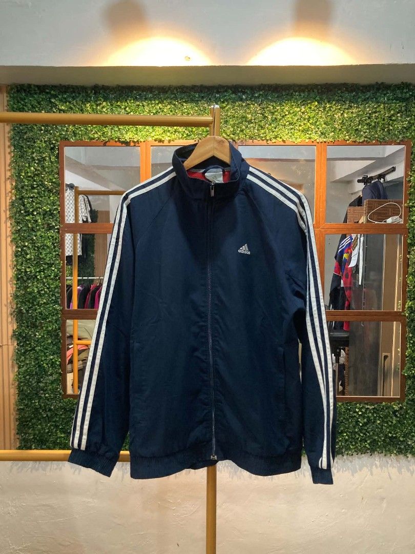 Adidas Track Jacket Navy Blue White Stripes (Category: Coats, Jackets and Outerwear) located in Trece Martires City. Submitted by djaothriftshop (Listing ID 1462782286, Image 1). Description: - Classic Adidas track jacket - Navy blue with white sleeve stripes - Full zip closure - Ribbed cuffs and hem - Versatile for casual wear or sports - Easy to style.