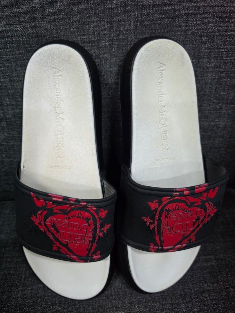 Alexander McQueen Skull Heart Slides Black Red (Category: Slippers & Slides) located in General Trias. Submitted by roselle2230 (Listing ID 1462833325, Image 3). Description: - Authentic Alexander McQueen slides - Color: Black with red skull heart graphic on strap - White insole with Alexander McQueen branding - Durable rubber sole with unique tread pattern - Comfortable and stylish for everyday wear.