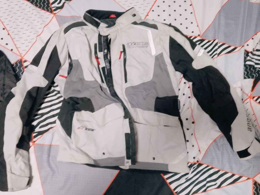 Alpinestars Tech-Touring Drystar Motorcycle Jacket (Category: Coats, Jackets and Outerwear) located in San Fernando. Submitted by tkdchester.1 (Listing ID 1462702053, Image 1). Description: - Alpinestars Tech-Touring Drystar motorcycle jacket - Color: Grey, black, and white - Features a ventilation system on the back - Multiple pockets on the front - Reflective detailing for enhanced visibility - Ideal for touring rides.