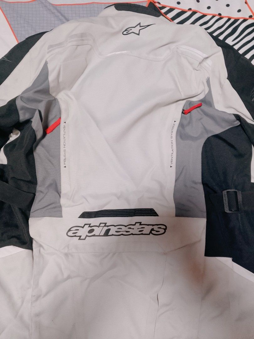 Alpinestars Tech-Touring Drystar Motorcycle Jacket (Category: Coats, Jackets and Outerwear) located in San Fernando. Submitted by tkdchester.1 (Listing ID 1462702053, Image 2). Description: - Alpinestars Tech-Touring Drystar motorcycle jacket - Color: Grey, black, and white - Features a ventilation system on the back - Multiple pockets on the front - Reflective detailing for enhanced visibility - Ideal for touring rides.
