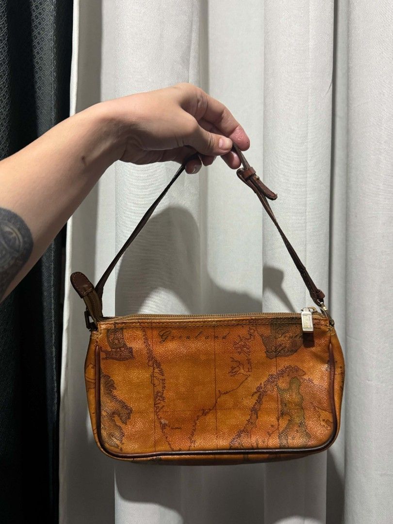 Alviero Martini 1a Classe Map Print Shoulder Bag (Category: Luxury Bags & Wallets) located in Manila. Submitted by mariecunan80818 (Listing ID 1462794615, Image 2). Description: - Authentic Vintage Alviero Martini shoulder bag - Iconic Geo map print - Genuine leather trim and strap - Secure zipper closure - Interior zippered pocket for essentials - A timeless addition to any collection - Shows normal signs of wear consistent with age.