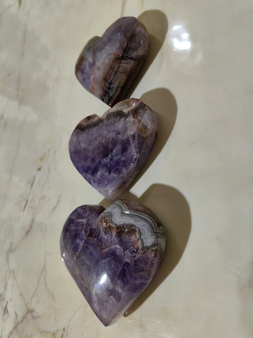 Amethyst Crystal Hearts (Category: Precious Stones) located in Tarlac. Submitted by jeremiah.curator.2026 (Listing ID 1462883106, Image 1). Description: Individual Purchase: P2,000 per heart. Special Collection Price: ALL three unique hearts for just P5,000. ✨ One Heart, Endless Possibilities: Wear it as a stunning Pendant on a necklace. Feature it as a prominent Centerpiece on a bracelet. Add natural beauty to your Home Decor or Crystal Collecti