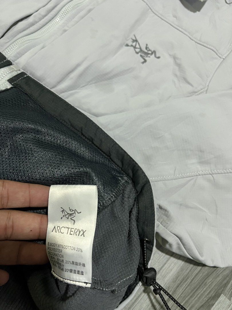 Arc'teryx Grey Hooded Jacket (Category: Coats, Jackets and Outerwear) located in Cavite. Submitted by arespichri90266 (Listing ID 1462700284, Image 3). Description: - Size L (20x26) - Grey Arc'teryx hooded jacket - Lightweight and practical design - Full zip closure - Adjustable hood for customized fit - Material: Cotton and Polyester blend - Perfect for outdoor adventures.