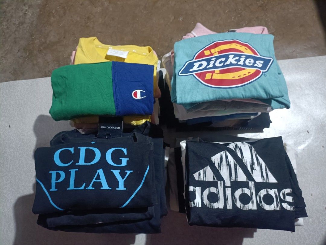 30pcs Tshirt x Polo Shirt (Category: Tshirts & Polo Shirts ) located in Taguig. Submitted by 22nd_street_thrift (Listing ID 1462829579, Image 1). Description: - Bundle of graphic tees featuring Dickies, CDG Play, Champion colorblock, and Adidas. - Ideal for everyday casual wear. - All shirts are neatly folded..