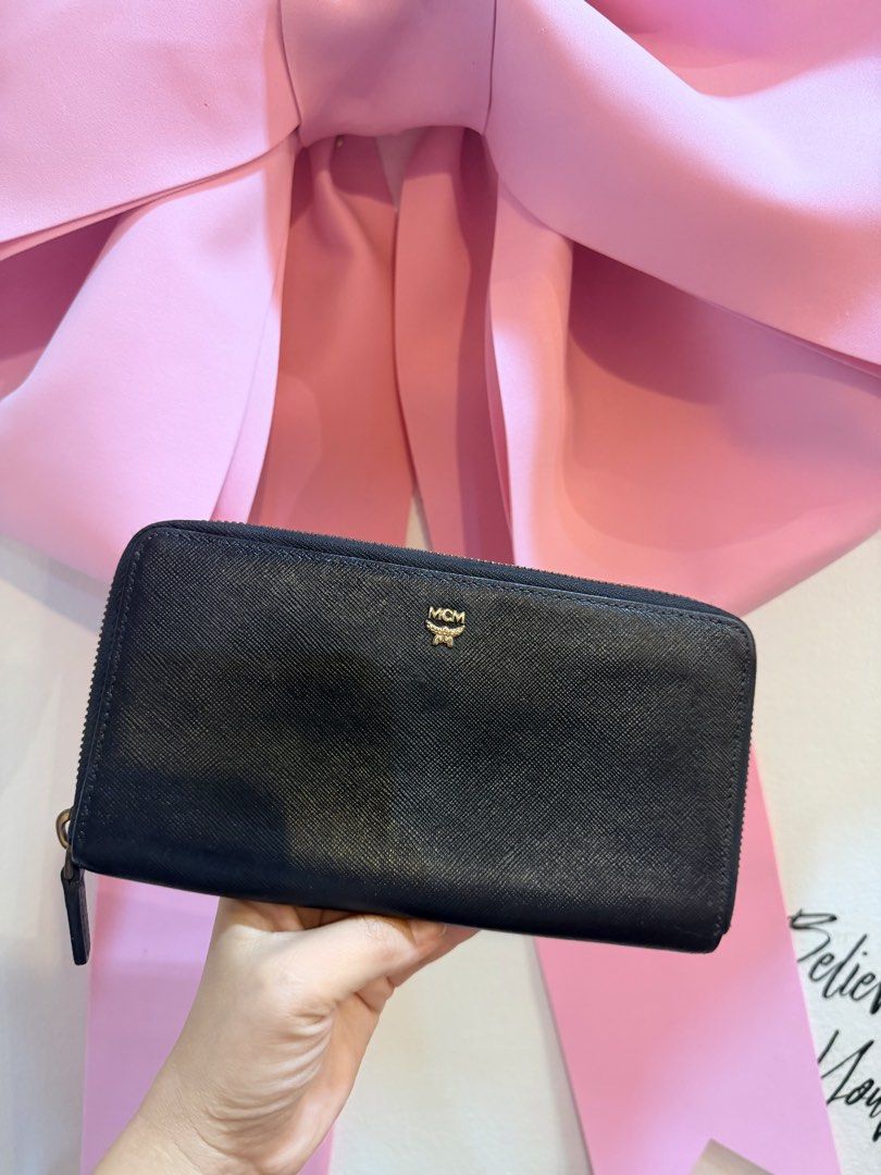 Authentic MCM Black Zip Around Wallet (Category: Luxury Bags & Wallets) located in Dumaguete. Submitted by lovebags.ph (Listing ID 1462825649, Image 2). Description: - Authentic MCM wallet - Color: Black leather - Features iconic gold MCM logo - Secure zip-around closure - Ample interior space for cards and cash - Ideal for everyday use - Feel free to ask any questions!.