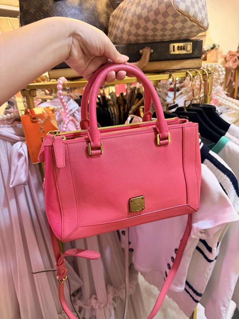 Authentic MCM Saffiano Pink Leather Top Handle Bag (Category: Luxury Bags & Wallets) located in Dumaguete. Submitted by lovebags.ph (Listing ID 1462827509, Image 1). Description: - Cute pink MCM bag - Saffiano leather - Gold hardware details - Detachable shoulder strap - Top zip closure - Spacious interior for essentials - Versatile for daily use or nights out.