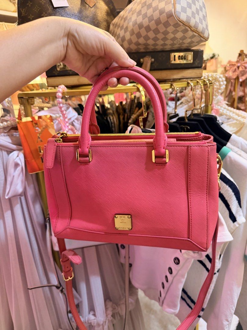 Authentic MCM Saffiano Pink Leather Top Handle Bag (Category: Luxury Bags & Wallets) located in Dumaguete. Submitted by lovebags.ph (Listing ID 1462827509, Image 3). Description: - Cute pink MCM bag - Saffiano leather - Gold hardware details - Detachable shoulder strap - Top zip closure - Spacious interior for essentials - Versatile for daily use or nights out.