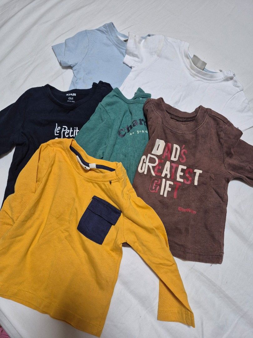 Baby Long Sleeve Tops Bundle (Various Brands/Sizes) (Category: Babies & Kids Fashion) located in Santo Tomas. Submitted by bellaswann18 (Listing ID 1462785807, Image 2). Description: - Bundle of 5 baby long sleeve tops - Includes brands like OshKosh B'gosh and Le Petit Bateau - Assorted colors: white, light blue, navy, dark green, mustard yellow - Features graphic prints and pocket details.