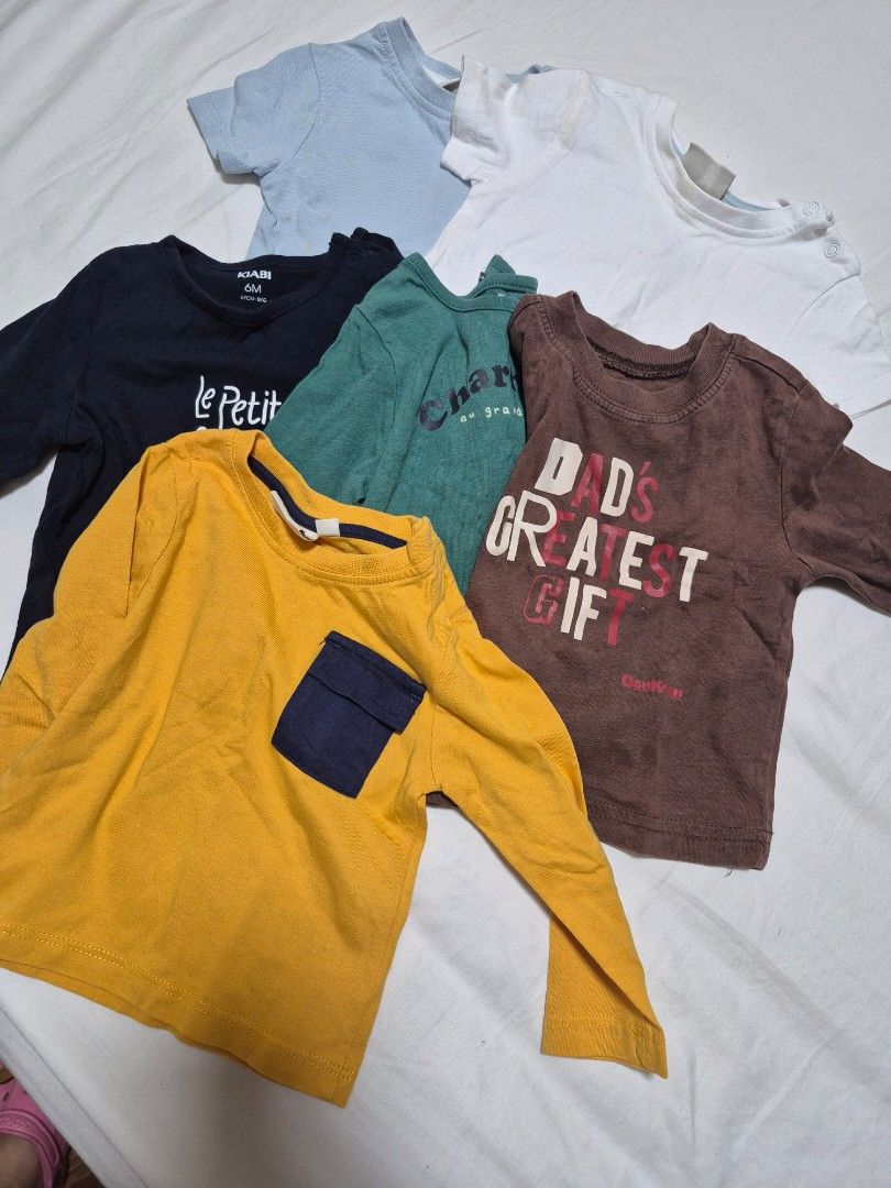 Baby Long Sleeve Tops Bundle (Various Brands/Sizes) (Category: Babies & Kids Fashion) located in Santo Tomas. Submitted by bellaswann18 (Listing ID 1462785807, Image 1). Description: - Bundle of 5 baby long sleeve tops - Includes brands like OshKosh B'gosh and Le Petit Bateau - Assorted colors: white, light blue, navy, dark green, mustard yellow - Features graphic prints and pocket details.