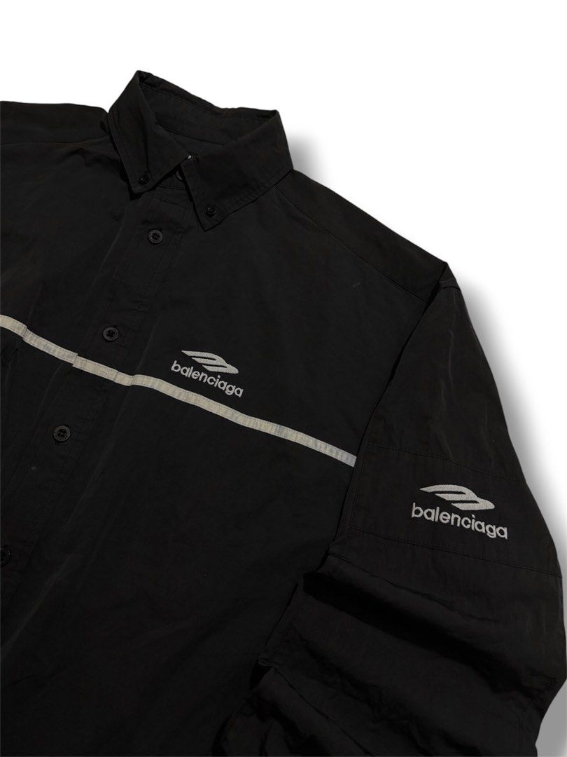 Balenciaga Black multi Logo Button-Up (Category: Tshirts & Polo Shirts ) located in Cabuyao City. Submitted by 0ld_souls (Listing ID 1462866001, Image 2). Description: - Authentic Balenciaga black button-up shirt - Size: Tag shows 2 - Features iconic Balenciaga logo on chest and sleeves - Stylish reflective stripe detail across front and back - Classic button closure - A great addition to any wardrobe.