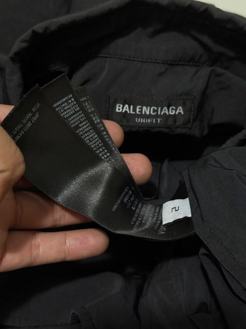 Balenciaga Black multi Logo Button-Up (Category: Tshirts & Polo Shirts ) located in Cabuyao City. Submitted by 0ld_souls (Listing ID 1462866001, Image 3). Description: - Authentic Balenciaga black button-up shirt - Size: Tag shows 2 - Features iconic Balenciaga logo on chest and sleeves - Stylish reflective stripe detail across front and back - Classic button closure - A great addition to any wardrobe.