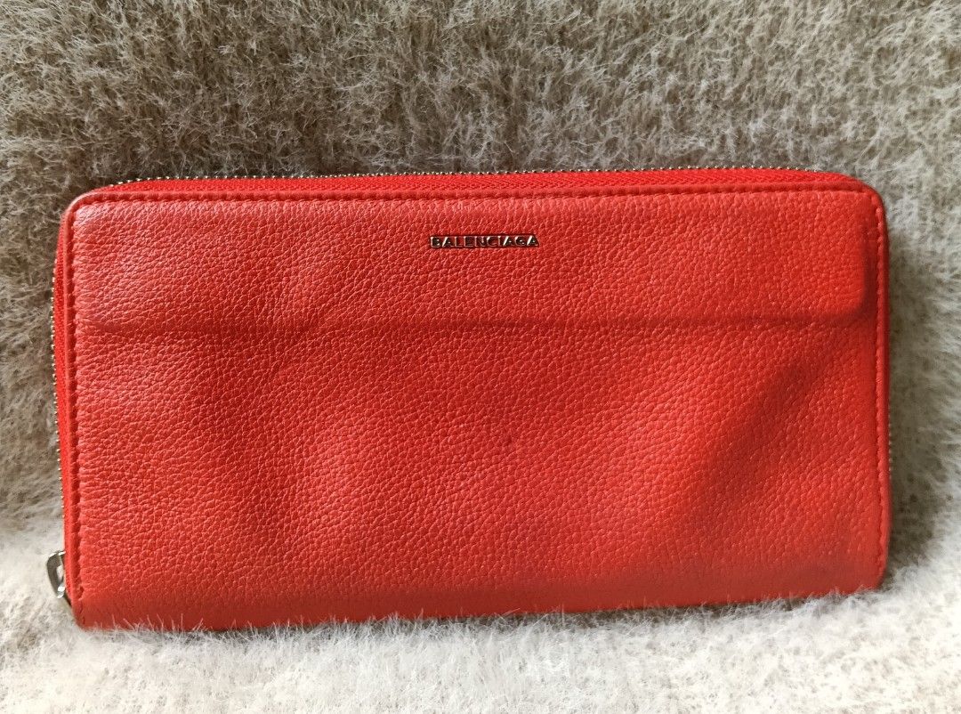 Balenciaga Red Leather Zip Around Wallet (Category: Luxury Bags & Wallets) located in Antipolo. Submitted by vastgem_4c8da8 (Listing ID 1462720576, Image 2). Description: - Balenciaga zip-around wallet - Vibrant red textured leather - Sleek silver hardware - Ample card slots and compartments - Perfect for organizing your essentials - A classic Balenciaga design.