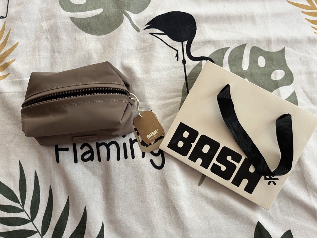 BASH Make Up Pouch in Brown (Category: Purses & Pouches) located in Makati City. Submitted by enelrach94 (Listing ID 1462690609, Image 3). Description: - Brand new BASH* cosmetic bag - Zipper closure - Ideal for organizing makeup or toiletries - Compact and portable size - Includes original tag and BASH* paper bag - Perfect for travel or daily use.