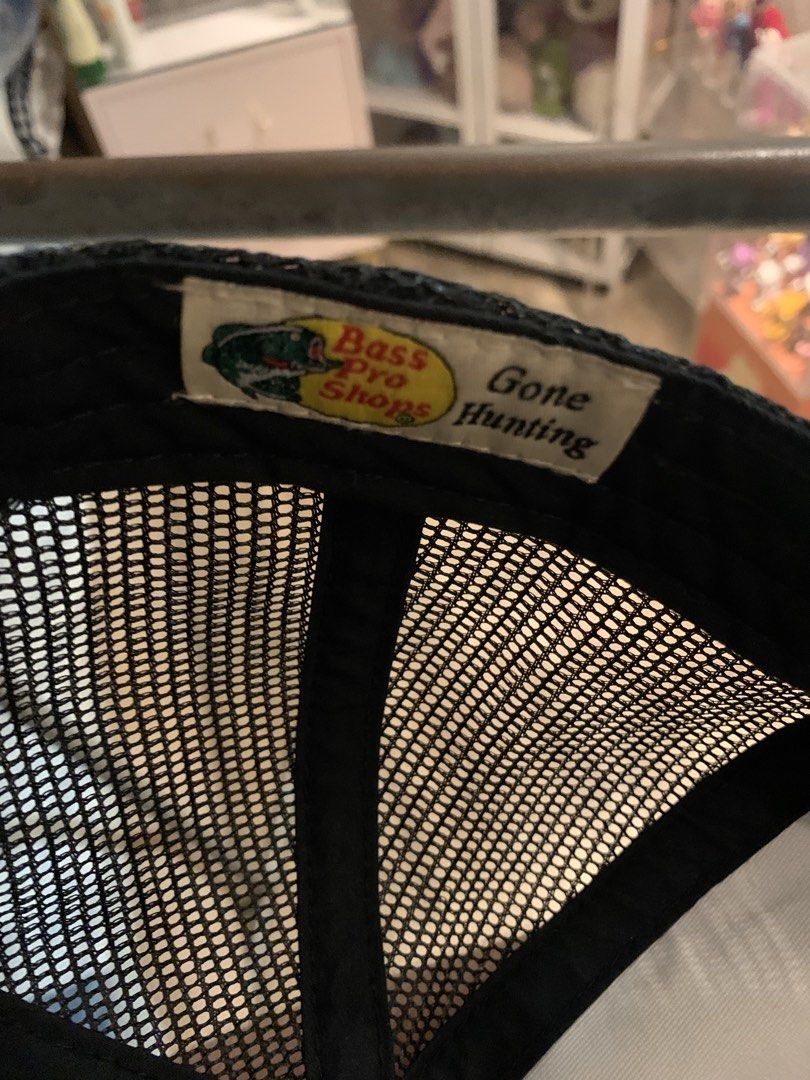 Bass Pro Shops "Gone Hunting" Trucker Cap (Category: Caps & Hats) located in Manila. Submitted by vintaurafindsco. (Listing ID 1462795323, Image 2). Description: - Classic Bass Pro Shops cap - Features iconic fish logo on the front - 'Gone Hunting' text detail on the side - Breathable mesh back for comfort - Adjustable strap for a customized fit - Ideal for outdoor enthusiasts and fishing trips.