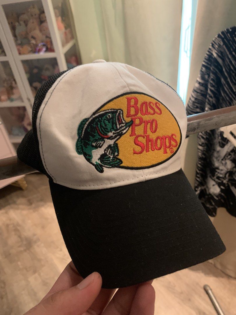 Bass Pro Shops "Gone Hunting" Trucker Cap (Category: Caps & Hats) located in Manila. Submitted by vintaurafindsco. (Listing ID 1462795323, Image 1). Description: - Classic Bass Pro Shops cap - Features iconic fish logo on the front - 'Gone Hunting' text detail on the side - Breathable mesh back for comfort - Adjustable strap for a customized fit - Ideal for outdoor enthusiasts and fishing trips.
