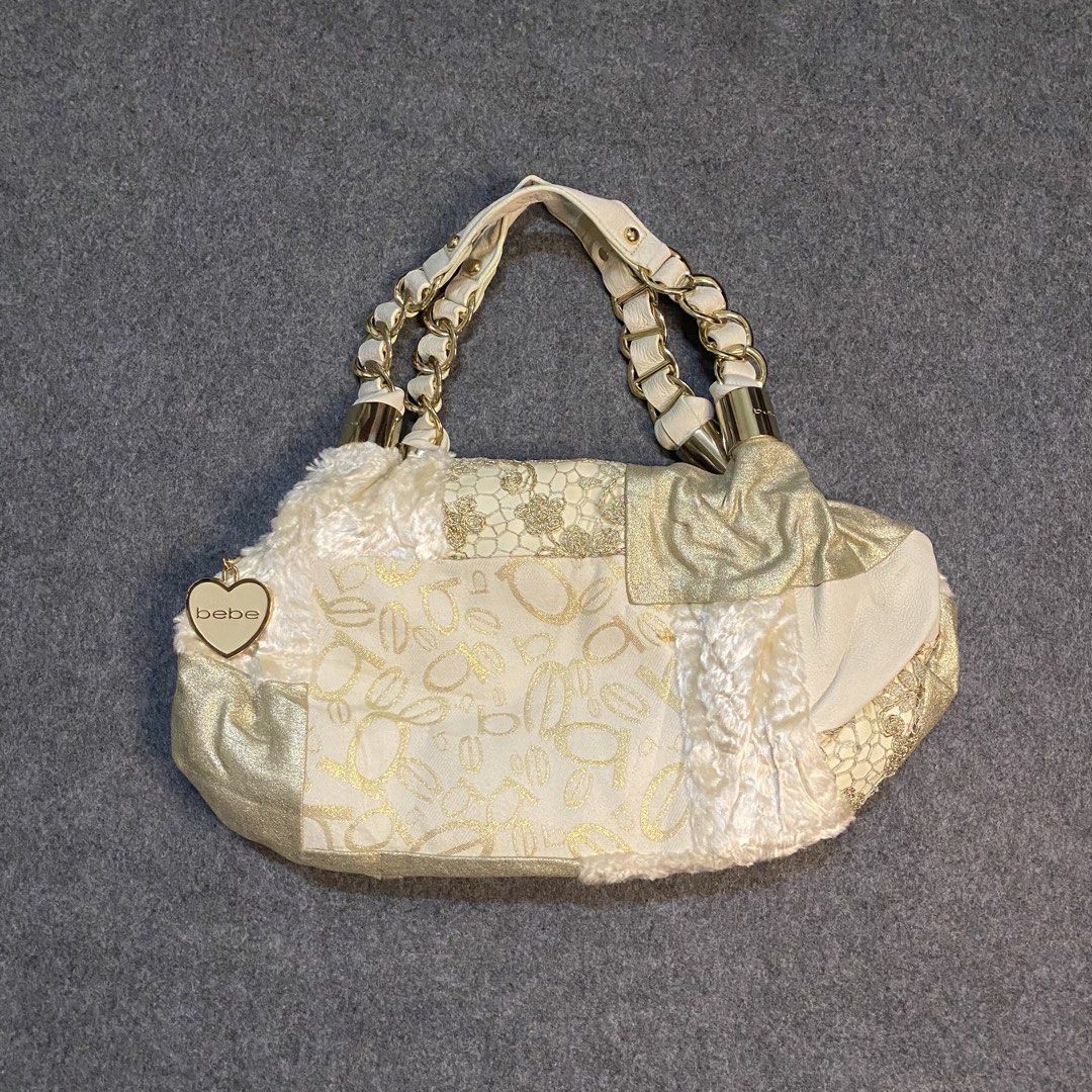 Bebe Patchwork Shoulder Bag Gold Cream Chain Straps (Category: Shoulder Bags) located in Cebu City. Submitted by callmejasonx (Listing ID 1462807662, Image 1). Description: - Adorable Bebe shoulder bag - Chic cream and gold patchwork design - Cozy fuzzy trim - Stylish gold chain strap details - Cute heart-shaped Bebe charm - Minor marks on the bottom (please check photos) - Perfect statement accessory -Issue:pinhole.