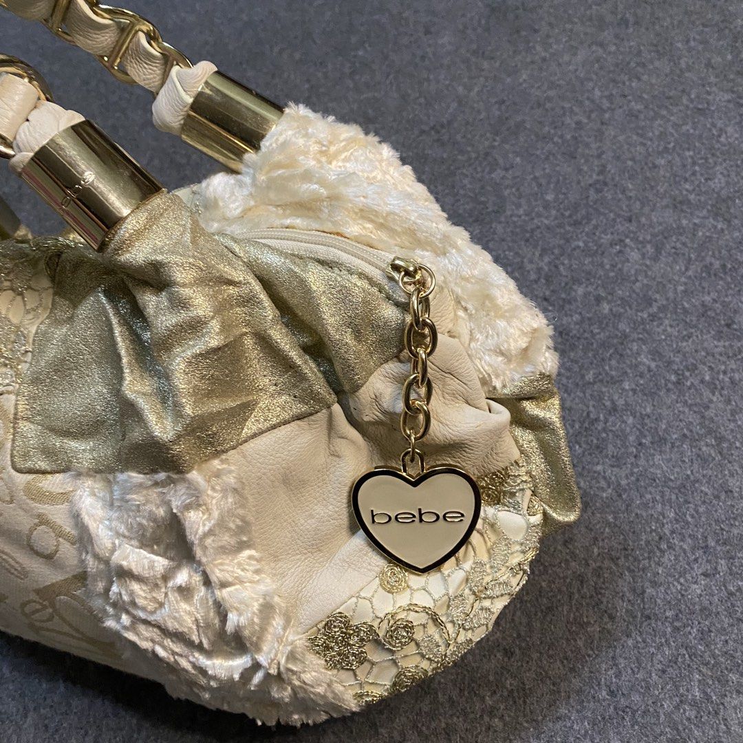 Bebe Patchwork Shoulder Bag Gold Cream Chain Straps (Category: Shoulder Bags) located in Cebu City. Submitted by callmejasonx (Listing ID 1462807662, Image 2). Description: - Adorable Bebe shoulder bag - Chic cream and gold patchwork design - Cozy fuzzy trim - Stylish gold chain strap details - Cute heart-shaped Bebe charm - Minor marks on the bottom (please check photos) - Perfect statement accessory -Issue:pinhole.