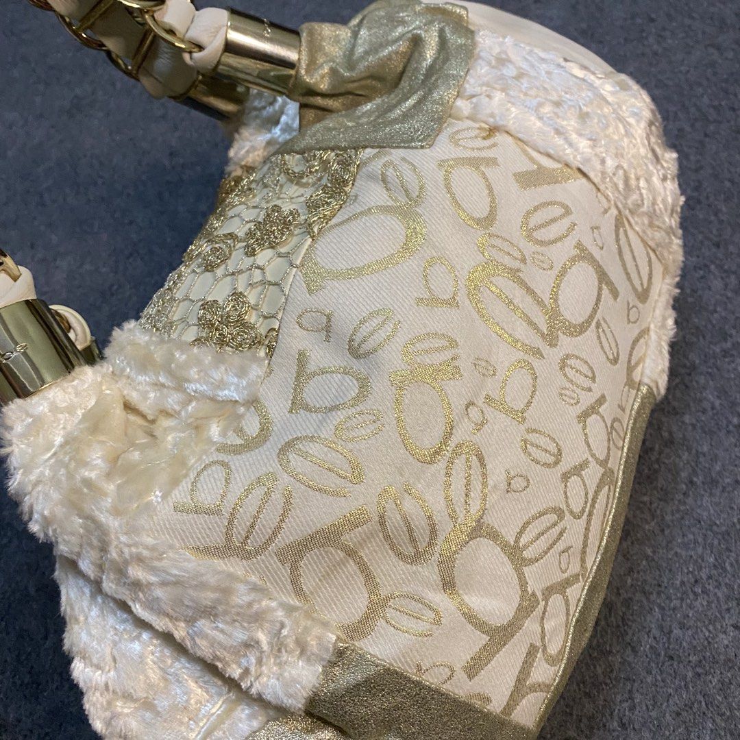 Bebe Patchwork Shoulder Bag Gold Cream Chain Straps (Category: Shoulder Bags) located in Cebu City. Submitted by callmejasonx (Listing ID 1462807662, Image 3). Description: - Adorable Bebe shoulder bag - Chic cream and gold patchwork design - Cozy fuzzy trim - Stylish gold chain strap details - Cute heart-shaped Bebe charm - Minor marks on the bottom (please check photos) - Perfect statement accessory -Issue:pinhole.