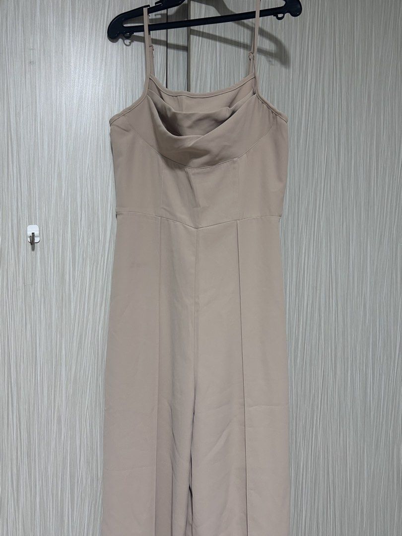 Beige Cowl Neck Spaghetti Strap Jumpsuit (Category: Jumpsuits) located in Manila. Submitted by juvy13 (Listing ID 1462774563, Image 1). Description: - Elegant beige jumpsuit - Flattering cowl neckline - Adjustable spaghetti straps for a perfect fit - Convenient back zipper closure - Stylish wide-leg design - Effortlessly dress up or down - Comfortable and chic for any occasion.