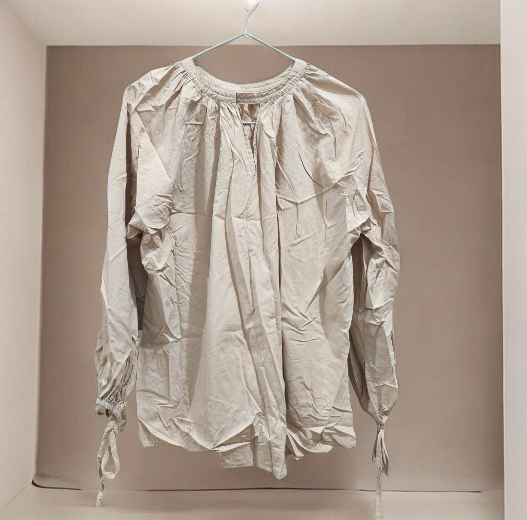 Beige Long Sleeve Blouse with Tie Cuffs (Category: Blouses) located in Taguig. Submitted by deyerreC2020 (Listing ID 1462842087, Image 1). Description: sale preloved nice cotton fabric beige blouse with gathered V-neck and tie-detail cuffs. Airy and comfortable for casual wear.like new condition blouse L-XL.bust 53 best for L sizes MOP: gcash/cash/maya.