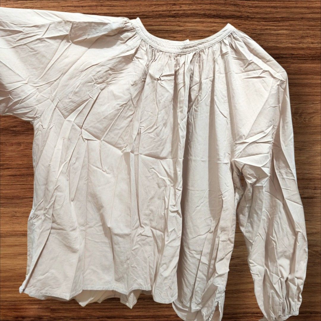 Beige Long Sleeve Blouse with Tie Cuffs (Category: Blouses) located in Taguig. Submitted by deyerreC2020 (Listing ID 1462842087, Image 2). Description: sale preloved nice cotton fabric beige blouse with gathered V-neck and tie-detail cuffs. Airy and comfortable for casual wear.like new condition blouse L-XL.bust 53 best for L sizes MOP: gcash/cash/maya.
