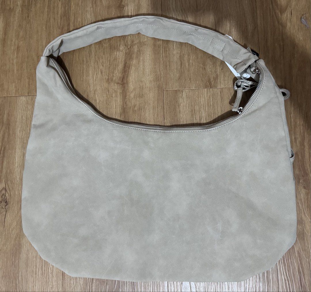 Beige Suede Hobo Bag with Tag (Category: Shoulder Bags) located in Manila. Submitted by jrc1994 (Listing ID 1462868264, Image 1). Description: - Light beige hobo bag - Soft suede-like material - Main zip compartment - Interior slip pockets - Original tag attached - Versatile neutral color - Ideal for everyday use -RSF decluttering -LP: 1,500.