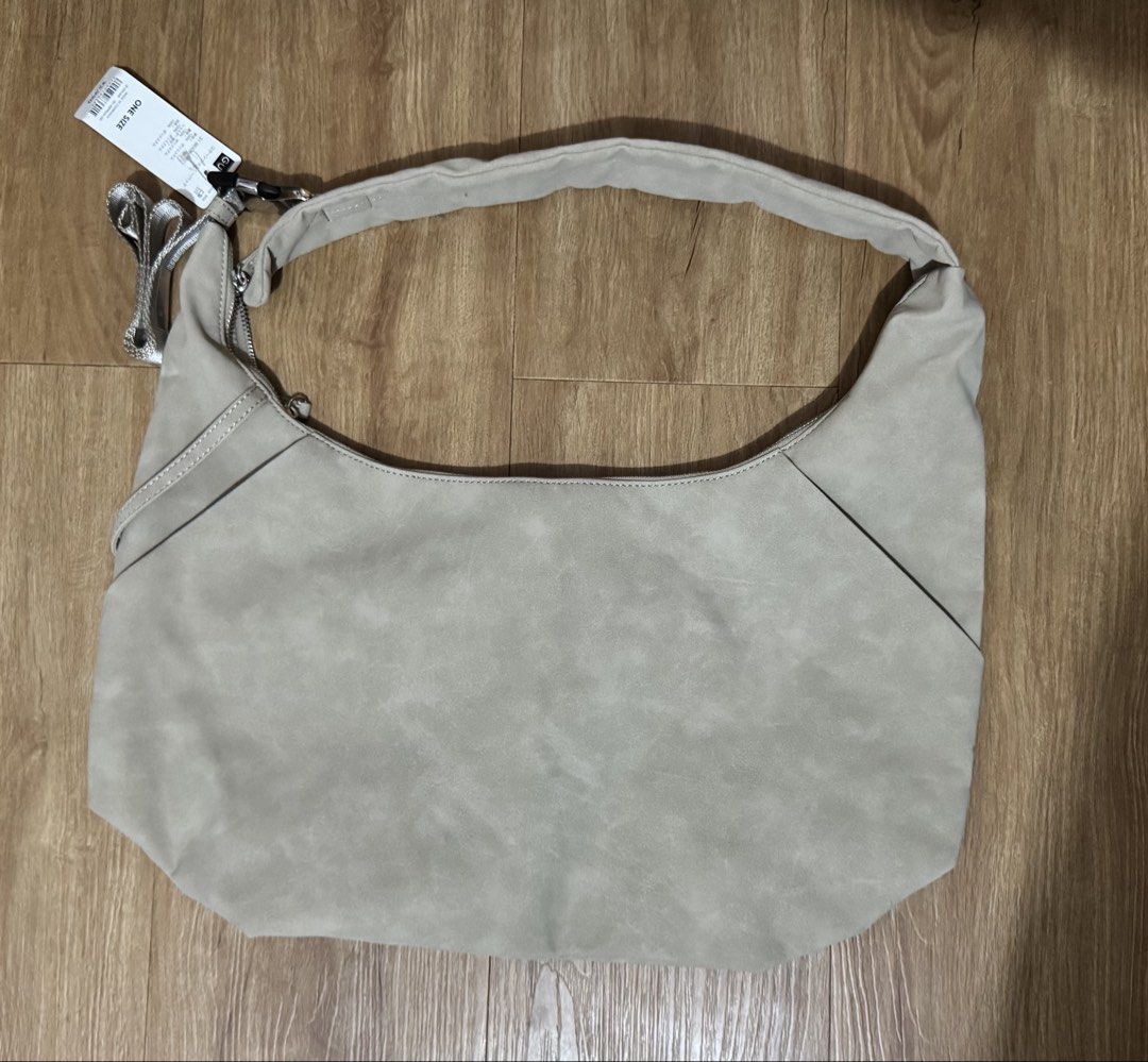 Beige Suede Hobo Bag with Tag (Category: Shoulder Bags) located in Manila. Submitted by jrc1994 (Listing ID 1462868264, Image 2). Description: - Light beige hobo bag - Soft suede-like material - Main zip compartment - Interior slip pockets - Original tag attached - Versatile neutral color - Ideal for everyday use -RSF decluttering -LP: 1,500.