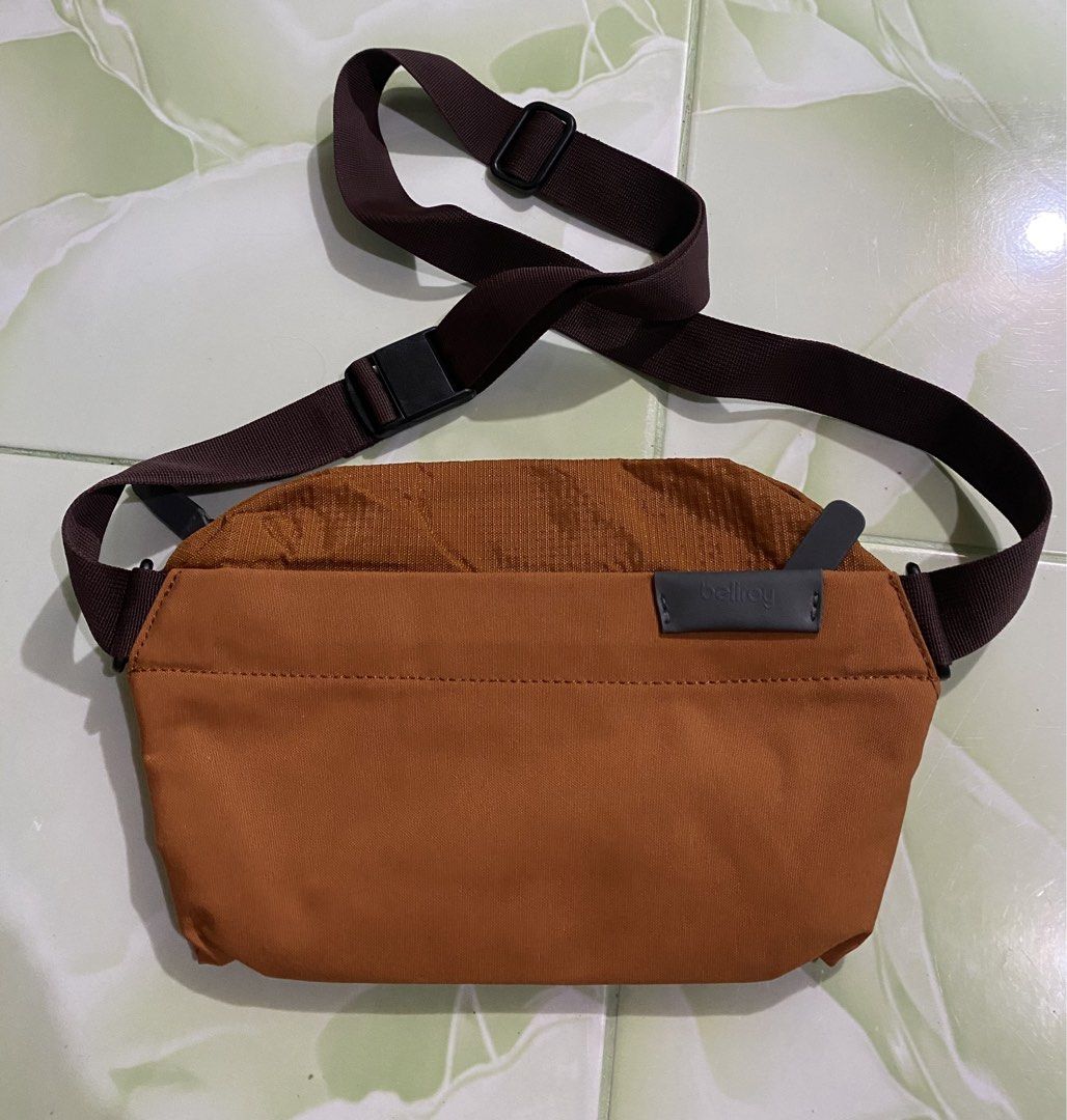 Bellroy Sling Bag - Burnt Orange (Category: Sling Bags) located in Pozorrubio. Submitted by izaykite2g (Listing ID 1462860993, Image 1). Description: - Bellroy sling bag in a stylish burnt orange color. - Adjustable strap for a comfortable, customized fit. - Secure main compartment with a zipper closure. - Features an internal tag with bag information. - Ideal for everyday carry or travel adventures. - Compact and highly practical design..