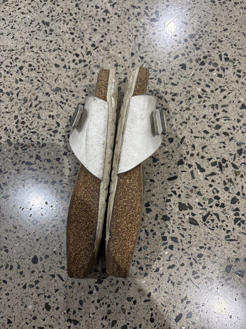 Birkenstocks size 35 (Category: Flats & Sandals) located in Manila. Submitted by everythingwlove (Listing ID 1462819243, Image 3). Description: - White leather Birkenstock sandals - Comfortable cork footbed - Adjustable buckle closure - Soles show some wear - Ideal for everyday comfort.
