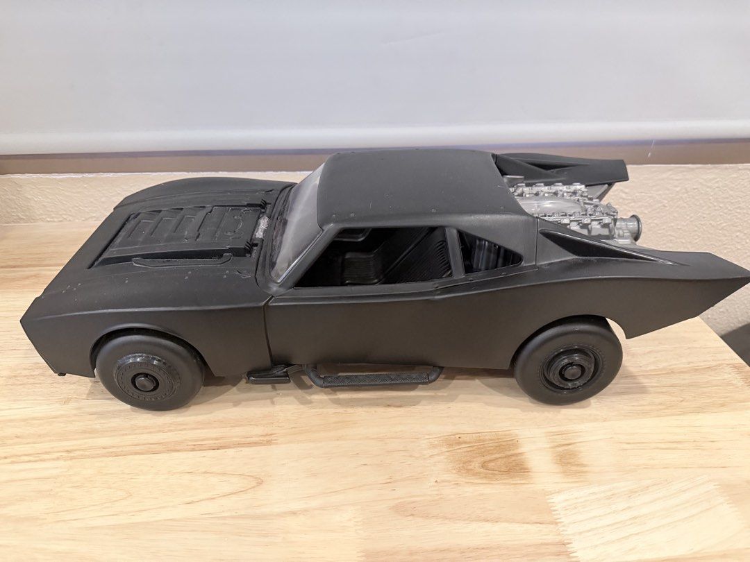 Black Batmobile Toy Car Model (Category: Vehicle & Diecast Models) located in Cebu City. Submitted by TheSunshineShop (Listing ID 1462779409, Image 2). Description: - 4 pcs: 790 each size: length: 22-23inches, width: 9.5 inches Sleek black toy car, reminiscent of the Batmobile. - Features a detailed engine sculpted at the back. - Constructed from durable plastic. - Ideal for toy car collectors or as a display piece..
