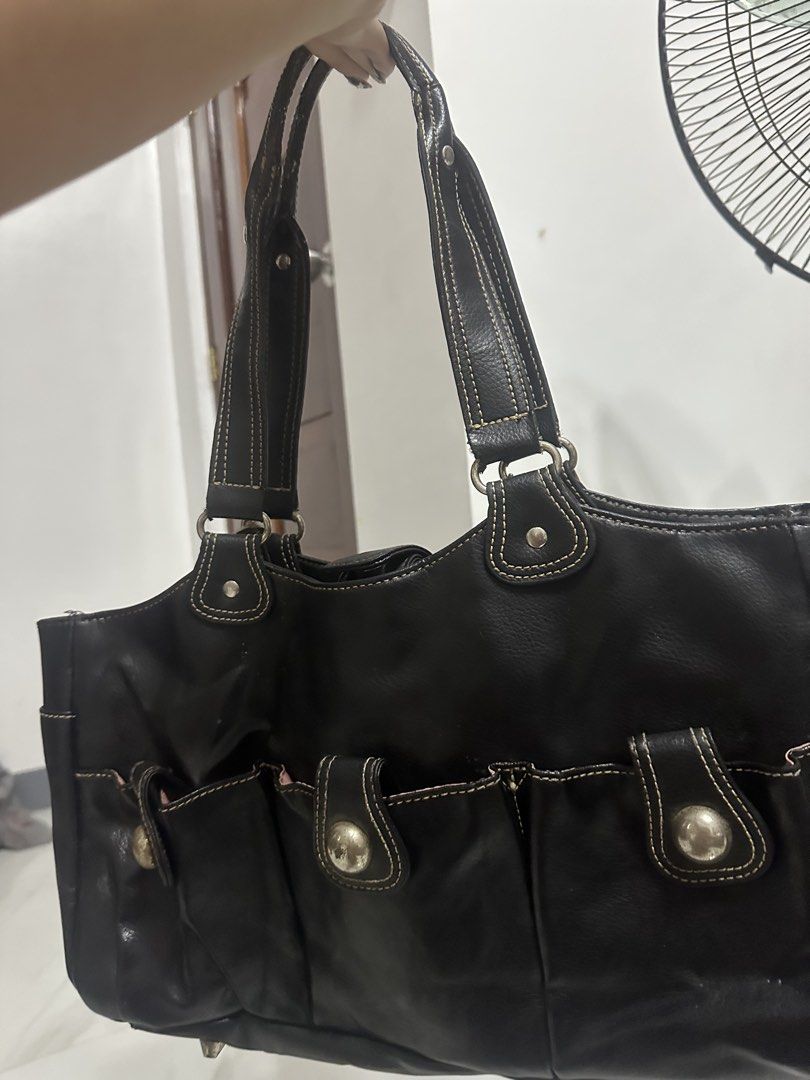 Black Leather AMM Handbag with Multiple Pockets (Category: Luxury Bags & Wallets) located in Manila. Submitted by goldenhorse-dafc (Listing ID 1462839913, Image 3). Description: - AMM black leather handbag - Multiple front pockets with snap closures - Interior features pink lining and several compartments - Leather straps with contrast stitching - Stylish and perfect for everyday use - Please check photos for detailed condition.