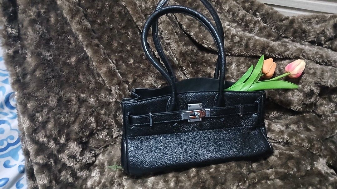 Black Leather Handbag with Silver Clasp (Category: Luxury Bags & Wallets) located in Taguig. Submitted by jegadablo (Listing ID 1462745784, Image 2). Description: - Classic black leather handbag - Secure silver clasp closure - Convenient top handles - Spacious interior - Ideal for daily use or special occasions - A versatile accessory for any outfit.