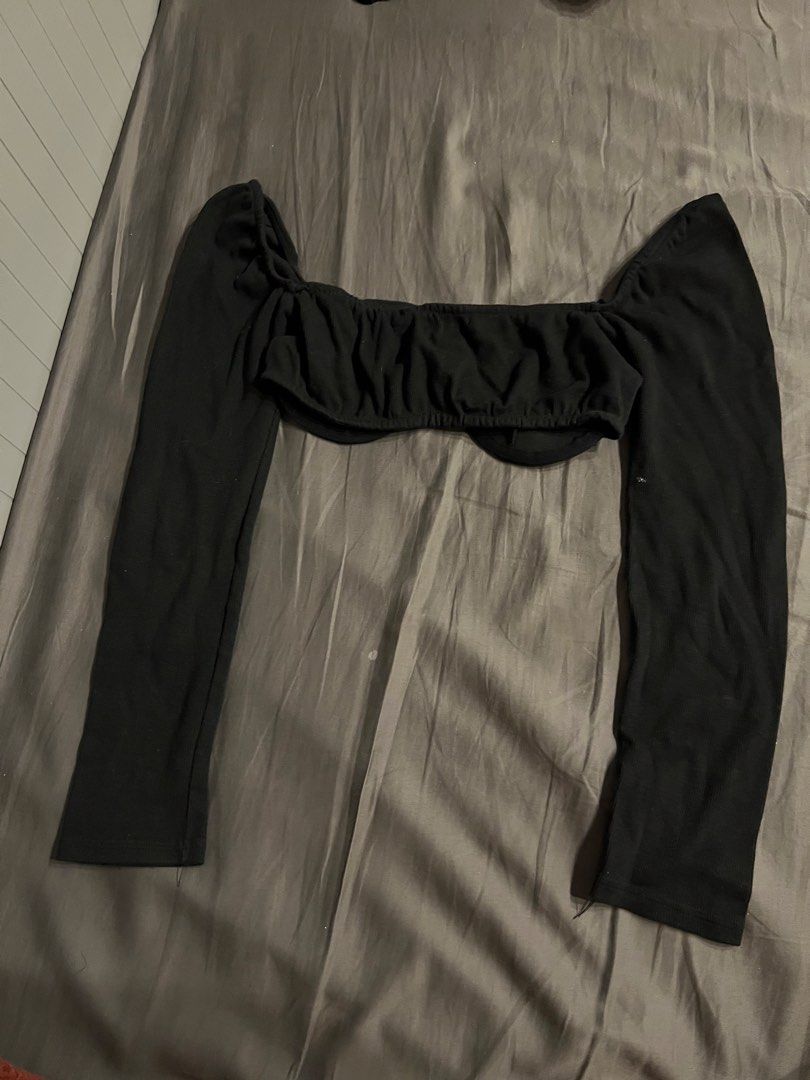 Black Long Sleeve Off-Shoulder Ruched Crop Top (Category: Longsleeves) located in Paranaque City. Submitted by dubaichocolei (Listing ID 1462739129, Image 2). Description: - Black long sleeve crop top - Off-shoulder design - Front ruched detailing - Ribbed fabric - Versatile for casual or night out looks - Pairs well with high-waisted jeans or skirts.