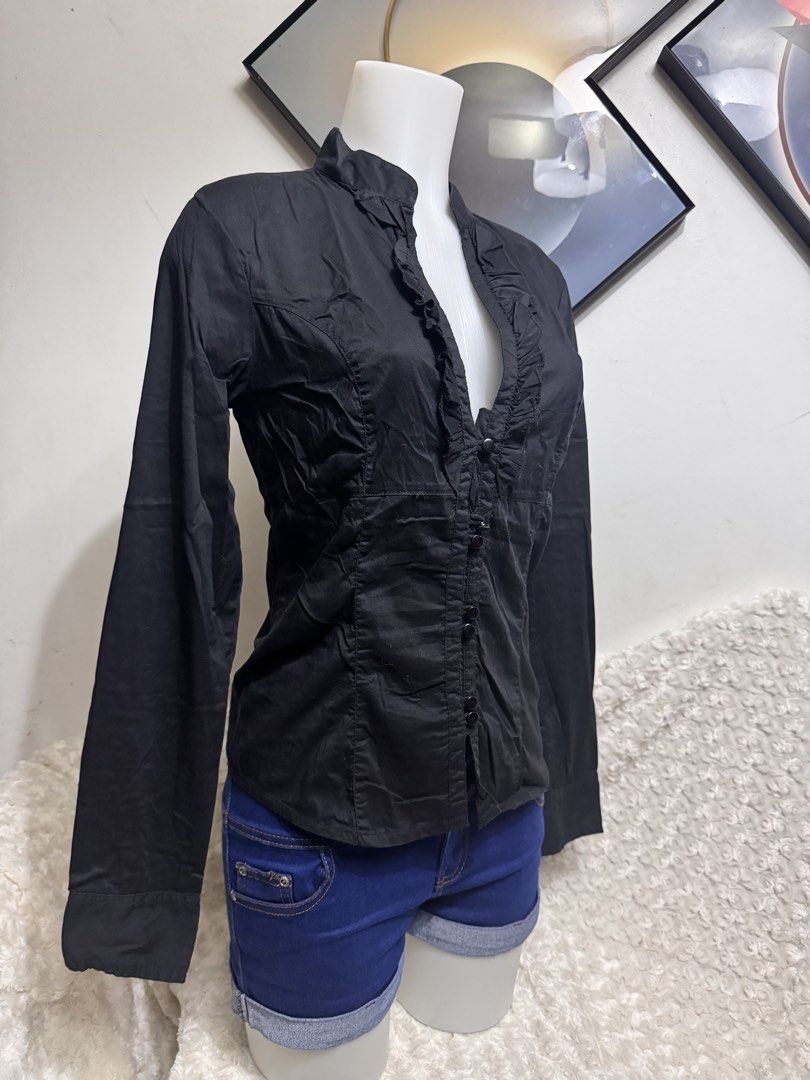 Black Long Sleeve Ruffle Front Button Up Shirt (Category: Blouses) located in Marikina City. Submitted by lorradel (Listing ID 1462729181, Image 2). Description: - Classic black long-sleeved shirt - Features a ruffled front detail - Button closure - Fitted silhouette - Versatile for dressing up or down - Easy to pair with skirts or trousers - MAY HAVE some washable stains (hindi maiiwasan) needs washing; had been stored - mannequin size 34-26-34 