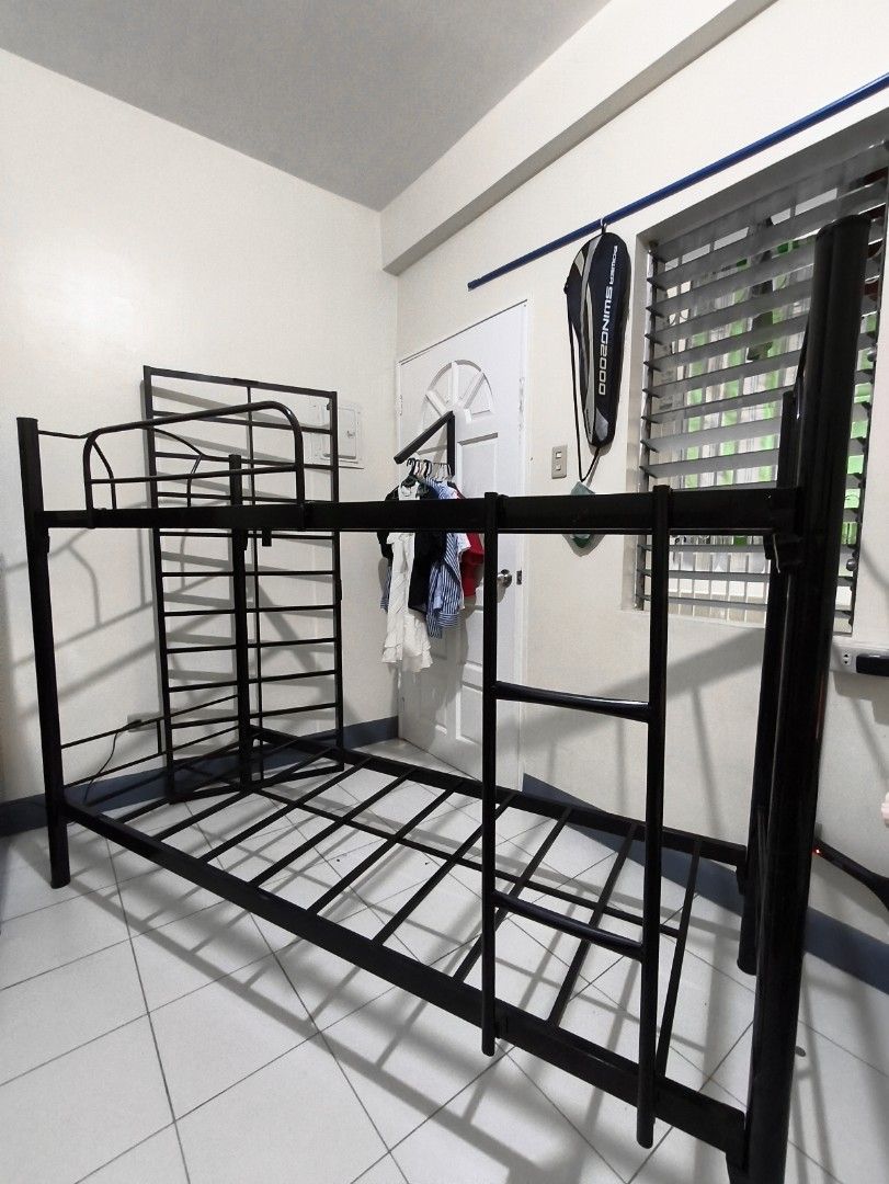 Black Metal Bunk Bed Frame with pull out (negotiable) (Category: Bed Frames & Mattresses) located in Manila. Submitted by tiktok_hellobloom.careteam (Listing ID 1462740321, Image 2). Description: - Sturdy black metal bunk bed frame - Includes ladder and guard rails for top bunk - Strong and durable construction - Fits two single mattresses - Disassembled for easy transport - Ideal for saving space.