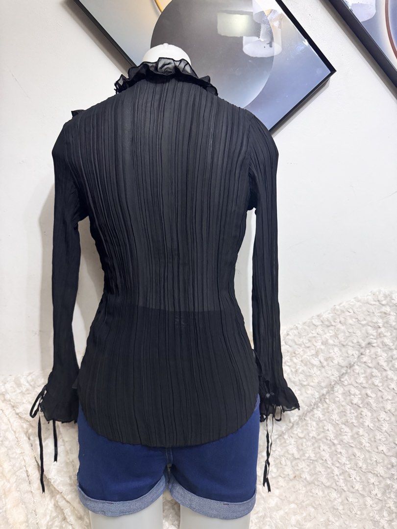 Black Pleated Ruffle Blouse with Beaded Collar (Category: Blouses) located in Marikina City. Submitted by lorradel (Listing ID 1462731541, Image 3). Description: - fits S-M - never used - Sheer black long-sleeve blouse - Ruffled neckline with beaded details - Pleated fabric throughout - Ribbon ties at the front and cuffs - Perfect for layering or wearing on its own - Adds a touch of flair to any outfit - MAY HAVE some washable stains (hindi maiiw