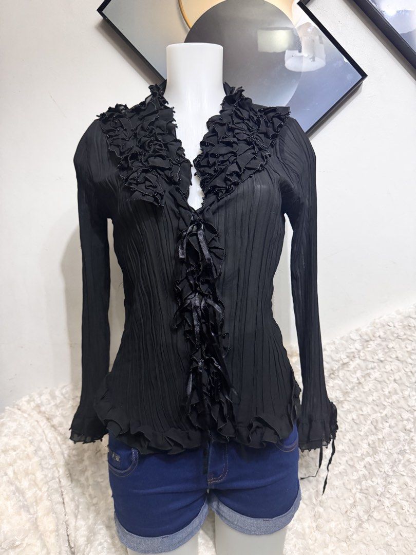 Black Pleated Ruffle Blouse with Beaded Collar (Category: Blouses) located in Marikina City. Submitted by lorradel (Listing ID 1462731541, Image 1). Description: - fits S-M - never used - Sheer black long-sleeve blouse - Ruffled neckline with beaded details - Pleated fabric throughout - Ribbon ties at the front and cuffs - Perfect for layering or wearing on its own - Adds a touch of flair to any outfit - MAY HAVE some washable stains (hindi maiiw