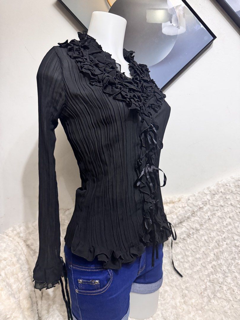 Black Pleated Ruffle Blouse with Beaded Collar (Category: Blouses) located in Marikina City. Submitted by lorradel (Listing ID 1462731541, Image 2). Description: - fits S-M - never used - Sheer black long-sleeve blouse - Ruffled neckline with beaded details - Pleated fabric throughout - Ribbon ties at the front and cuffs - Perfect for layering or wearing on its own - Adds a touch of flair to any outfit - MAY HAVE some washable stains (hindi maiiw