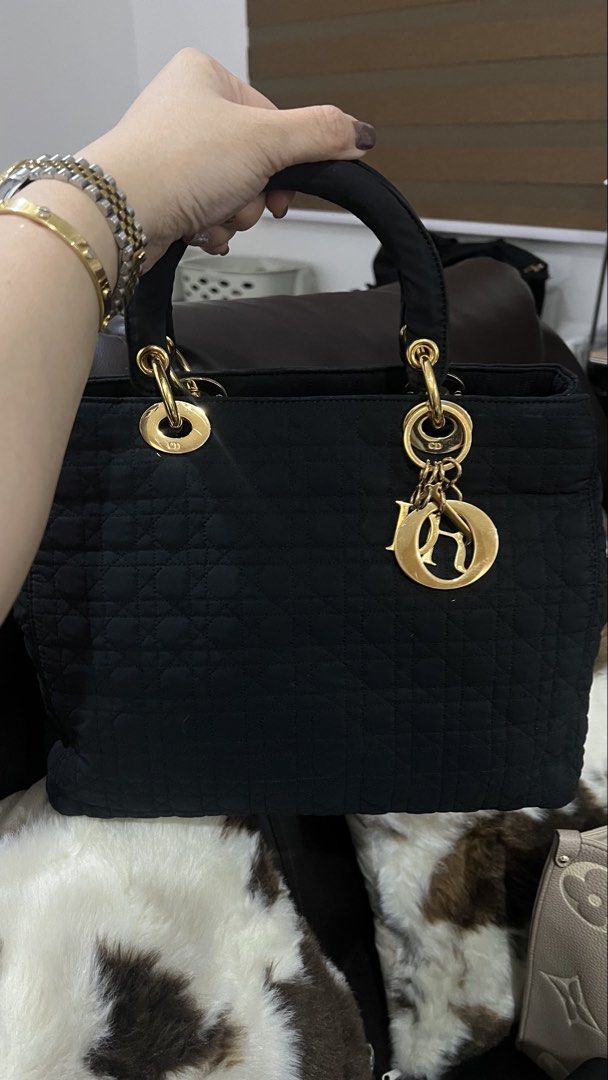 Black Quilted canvass Lady Dior Bag (Category: Luxury Bags & Wallets) located in Cainta. Submitted by katchers (Listing ID 1462880224, Image 2). Description: - Authentic classic vintage black canvass Lady Dior bag - Elegant quilted pattern all over - Shiny gold hardware with signature Dior charms - Convenient top handle for easy carrying - Versatile: ideal for everyday use or special events.