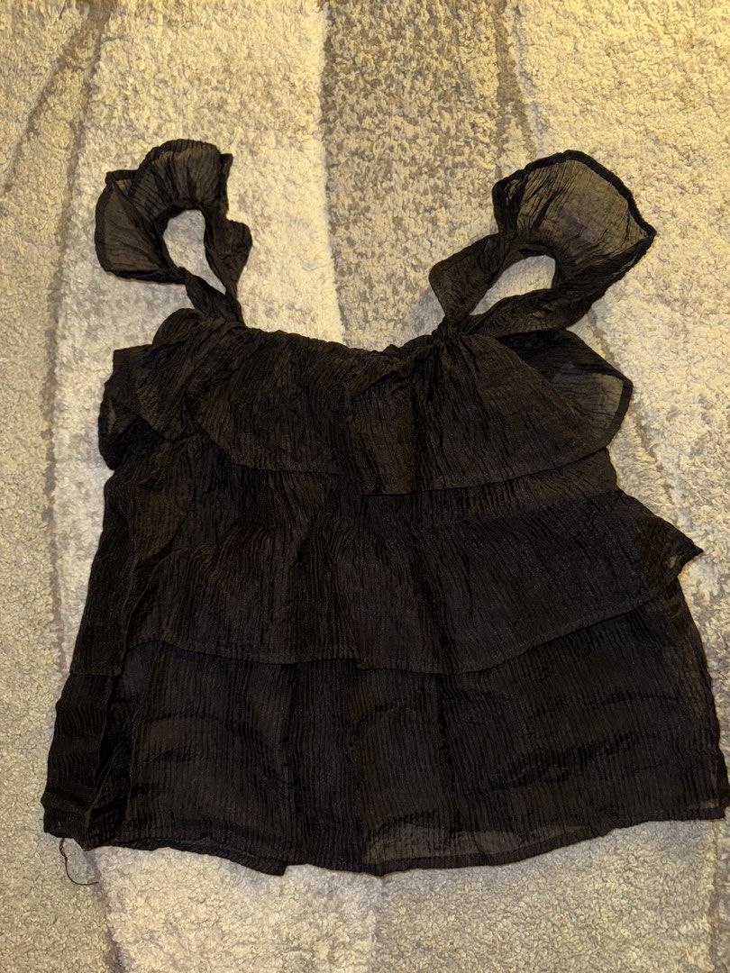 Black Ruffled Tiered Tank Top with Tie Straps (Category: Sleeveless) located in Cebu City. Submitted by cholinesterase (Listing ID 1462862575, Image 1). Description: - Cute black ruffled top - Features tiered layers - Adjustable tie straps - Crinkled fabric texture - Versatile for day or night wear - Easily pairs with jeans or skirts.