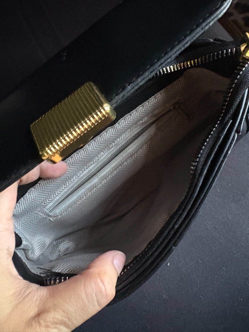 Black Shoulder Bag with Gold Clasp (Category: Shoulder Bags) located in Calamba. Submitted by leeadriannn796 (Listing ID 1462710253, Image 2). Description: - Classic black shoulder bag - Gold-tone clasp closure on front flap - Interior zippered pocket - Adjustable strap - Ideal for everyday use.