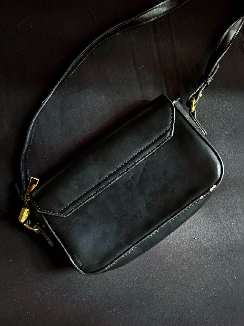Black Shoulder Bag with Gold Clasp (Category: Shoulder Bags) located in Calamba. Submitted by leeadriannn796 (Listing ID 1462710253, Image 3). Description: - Classic black shoulder bag - Gold-tone clasp closure on front flap - Interior zippered pocket - Adjustable strap - Ideal for everyday use.