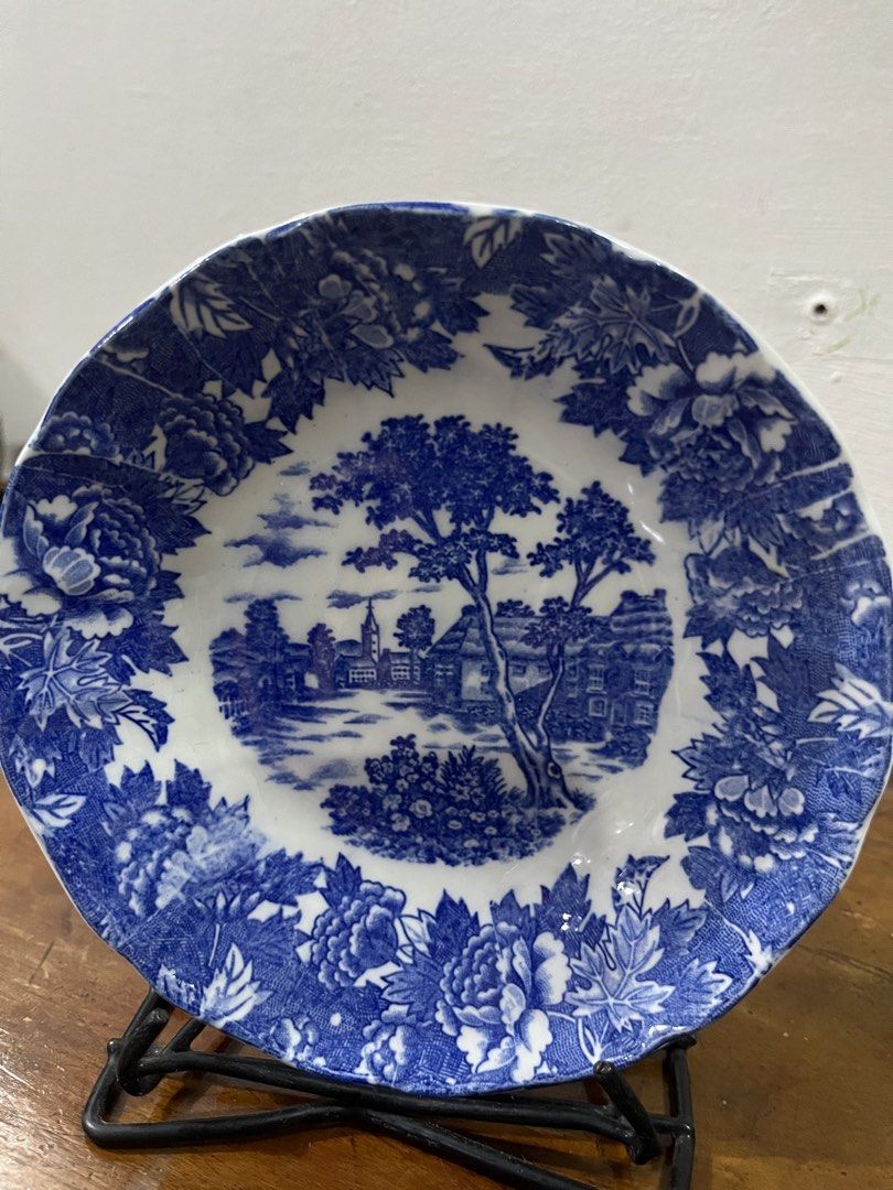 Blue and White Scenic Decorative Plate (Category: Other Home Decor) located in Taguig. Submitted by minmin_parker (Listing ID 1462834664, Image 2). Description: - Vintage blue and white decorative plate - Features a scenic landscape with trees and buildings - Elegant floral pattern on the border - Approximately 6 inches in diameter - Ideal for home decor, display, or adding to a collection - Adds a classic and timeless touch.